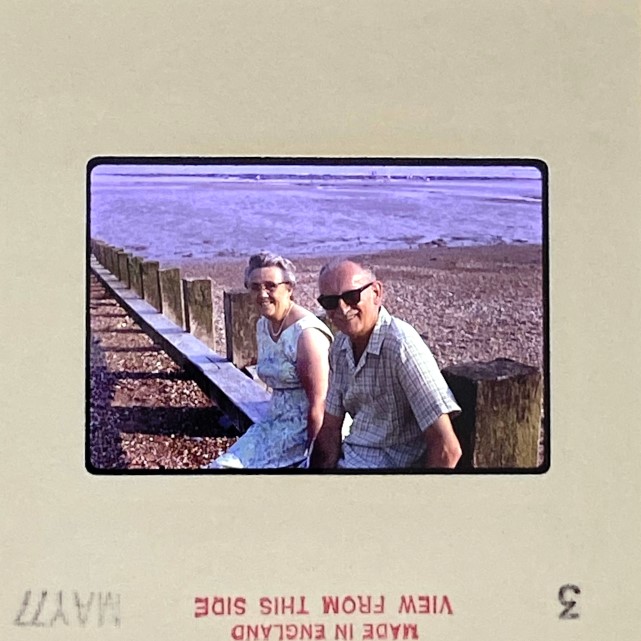 slide of a couple sitting on a breakwater with noticeable colour shift – original image ready for professional slide restoration