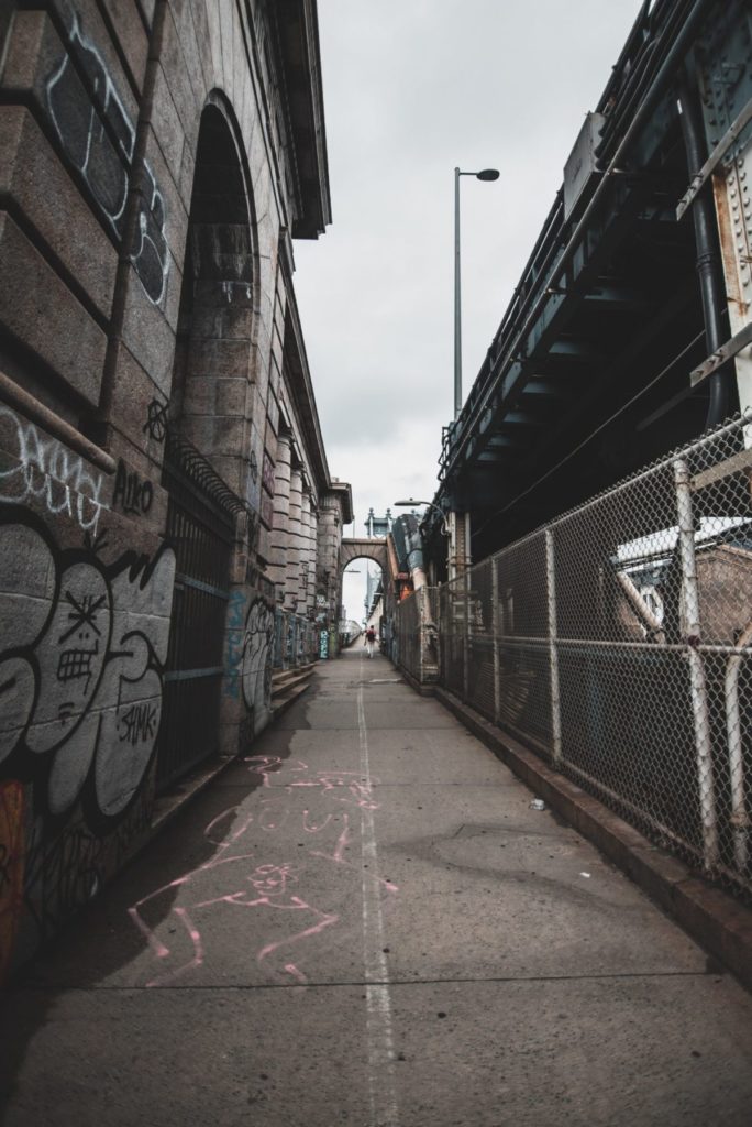 aka alt-text-photo-of-walkway-creating-illusion-of-buildings-leaning-to-illustrate-perspective